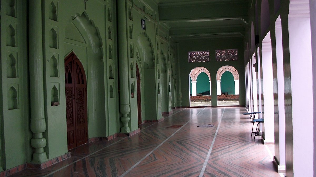 The green arcaded corridor of the mosque