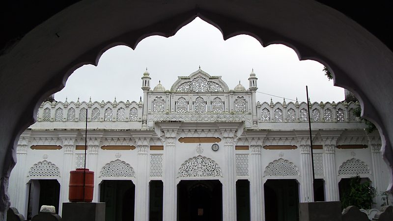 The mosque façade seen through the campus arch