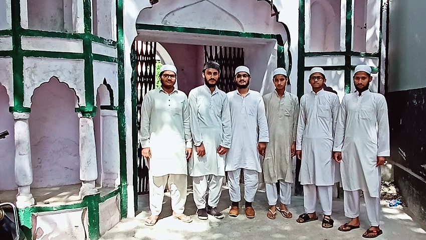 Senior students beneath the courtyard arches